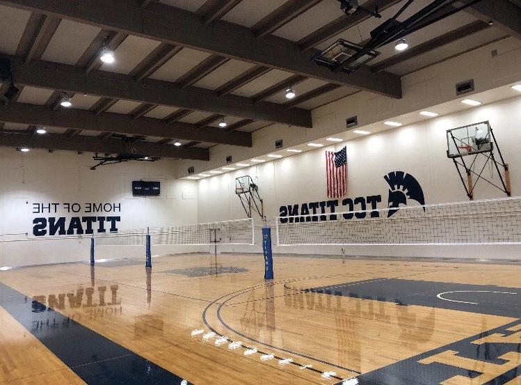 a wide shot of the open gym with a volleyball net set up